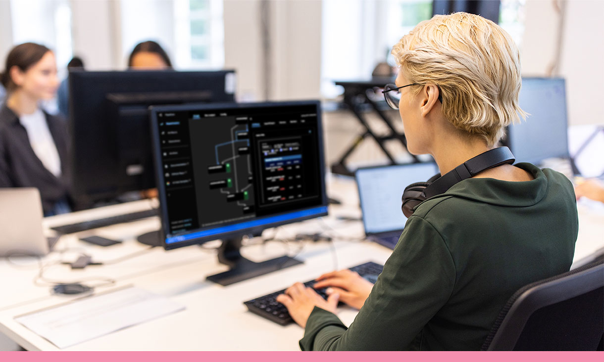 A person works on their computer in an office.