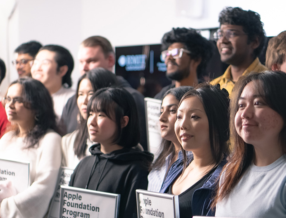 A group of students listen attentively at the Apple Foundation Program at RMIT.