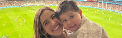 Camile sharing a hug with her son on the stadium grounds.