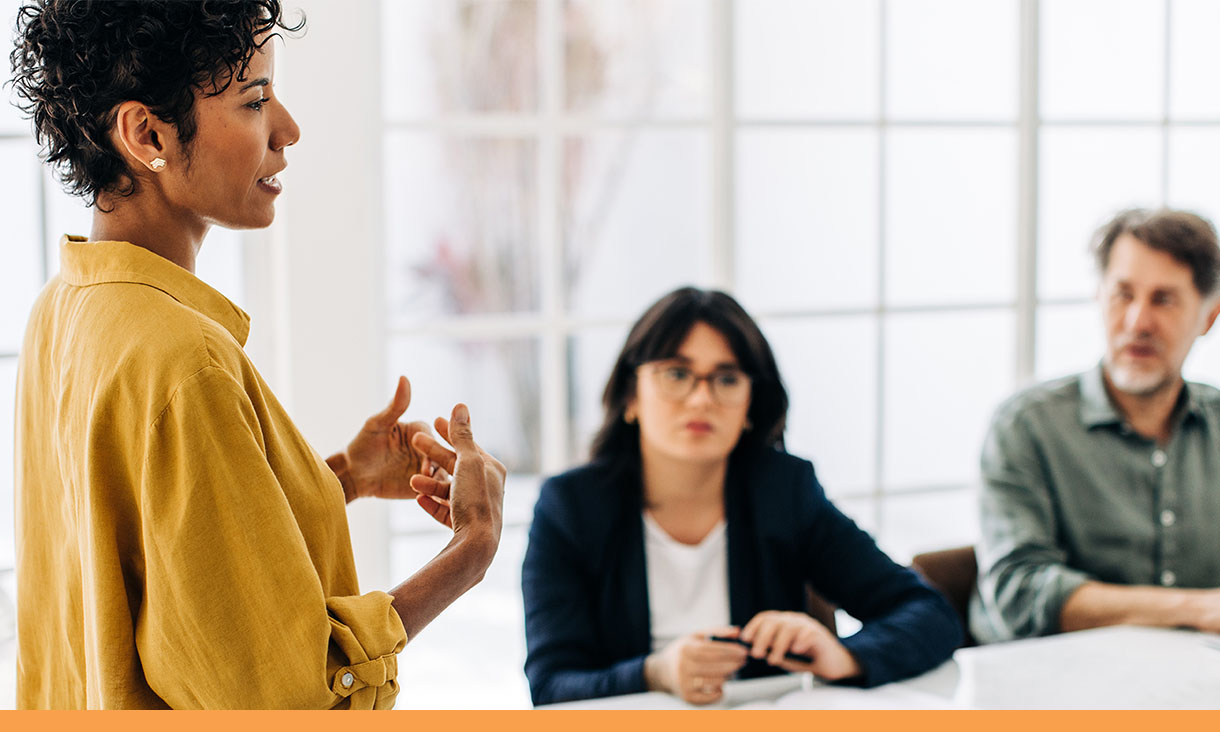 A woman presents at a meeting.