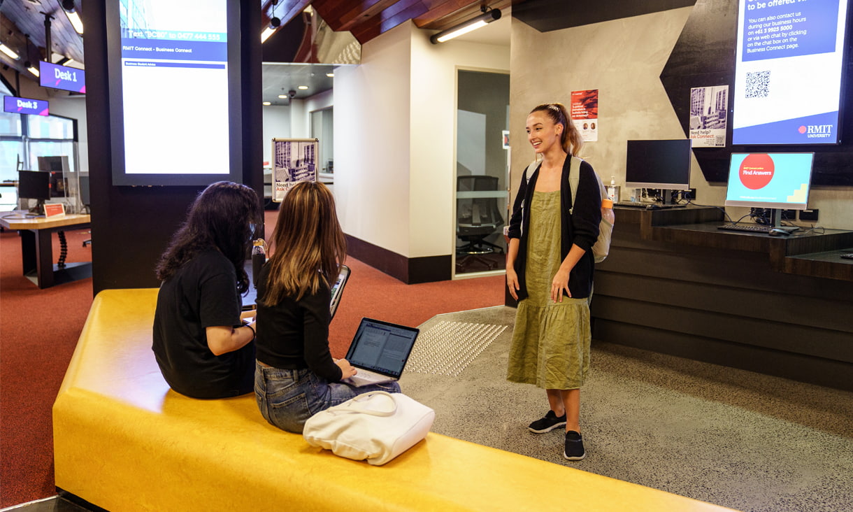 Three students talking in an spaceous lounge