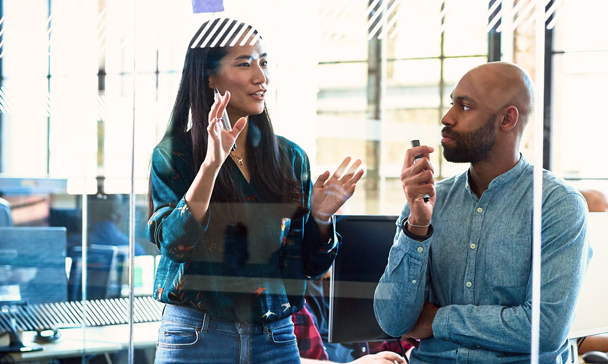 Male and female holding texters while in discussion