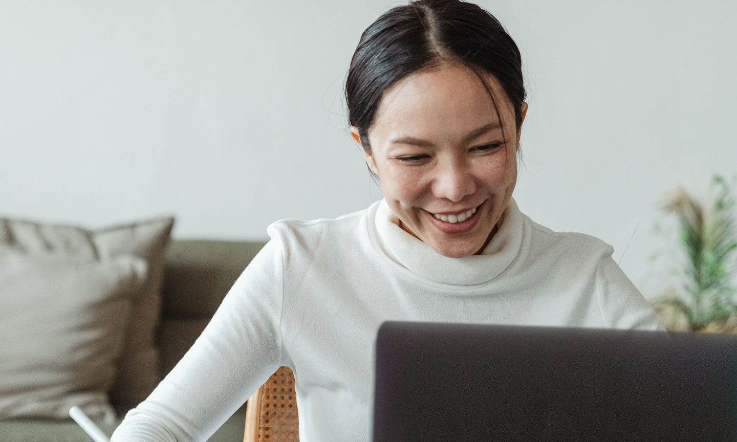 Student smiling at laptop