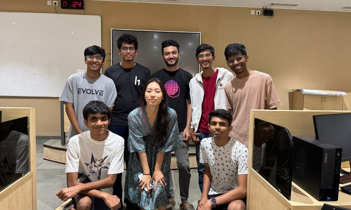 Group of students posing for photo in classroom