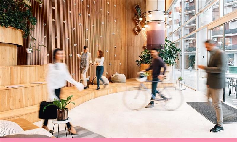 A group of coworkers in an open plan office.